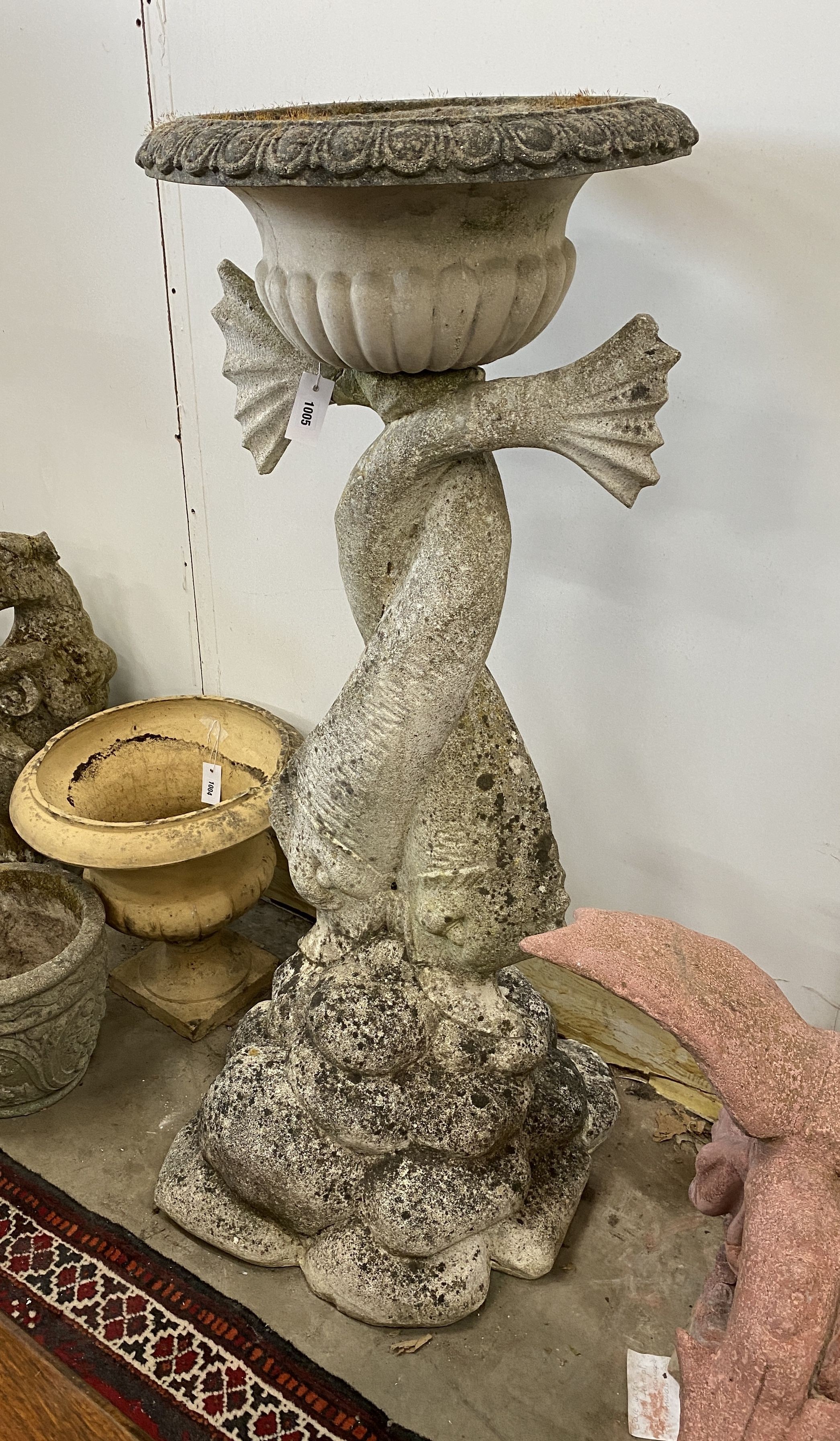 A large reconstituted stone dolphin garden planter, height 132cm